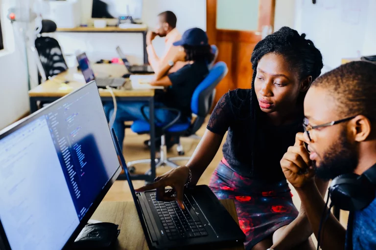 woman and a man working in front of a computer