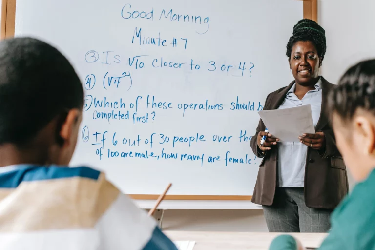elementary students listening to their teacher