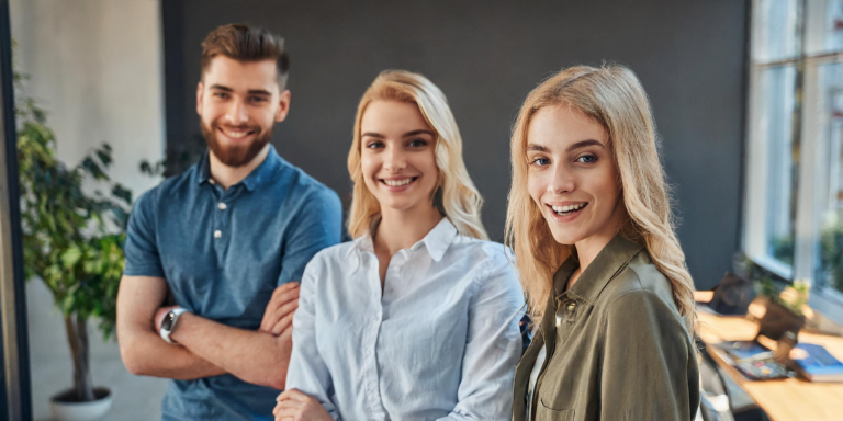 3 young adults smiling looking forward
