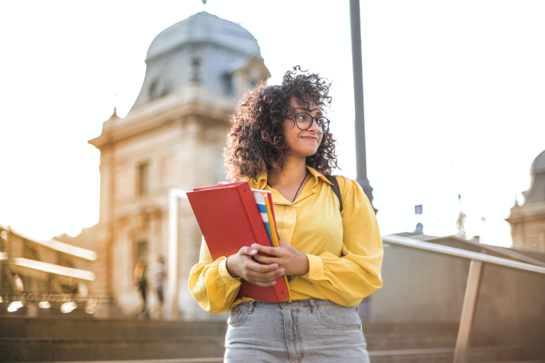 Motivational Quotes About Studying Hard: college student holding her binders