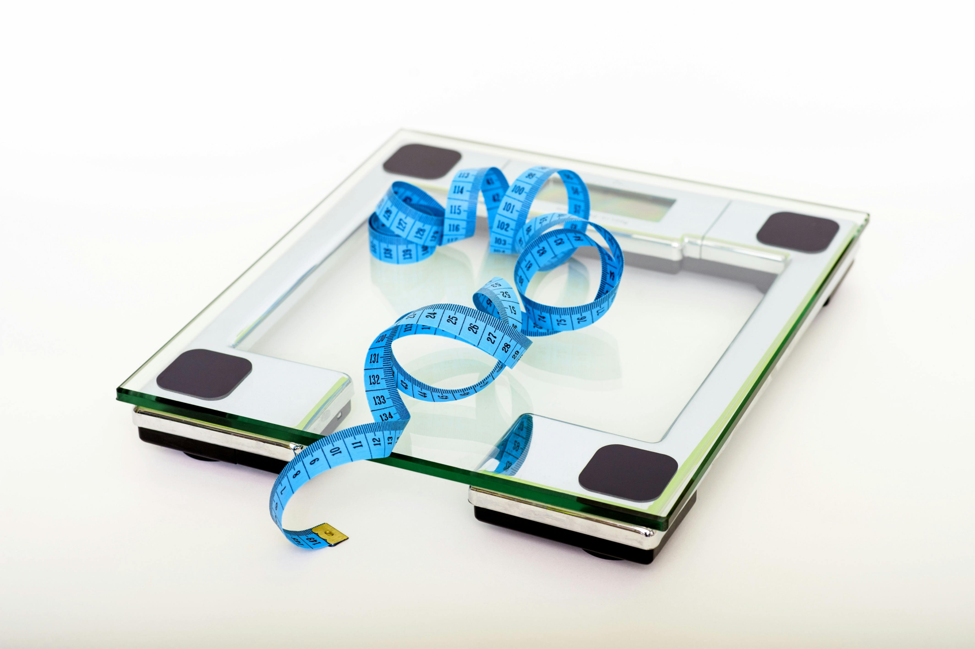 Get Into Weight Loss Mode: a tape measure and a weighing scale for weight loss motivation