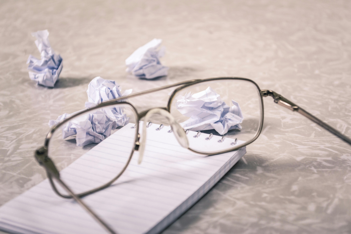 How to Silence Your Mind and Stop Overthinking: eyeglassed over a notebook near crampled papers